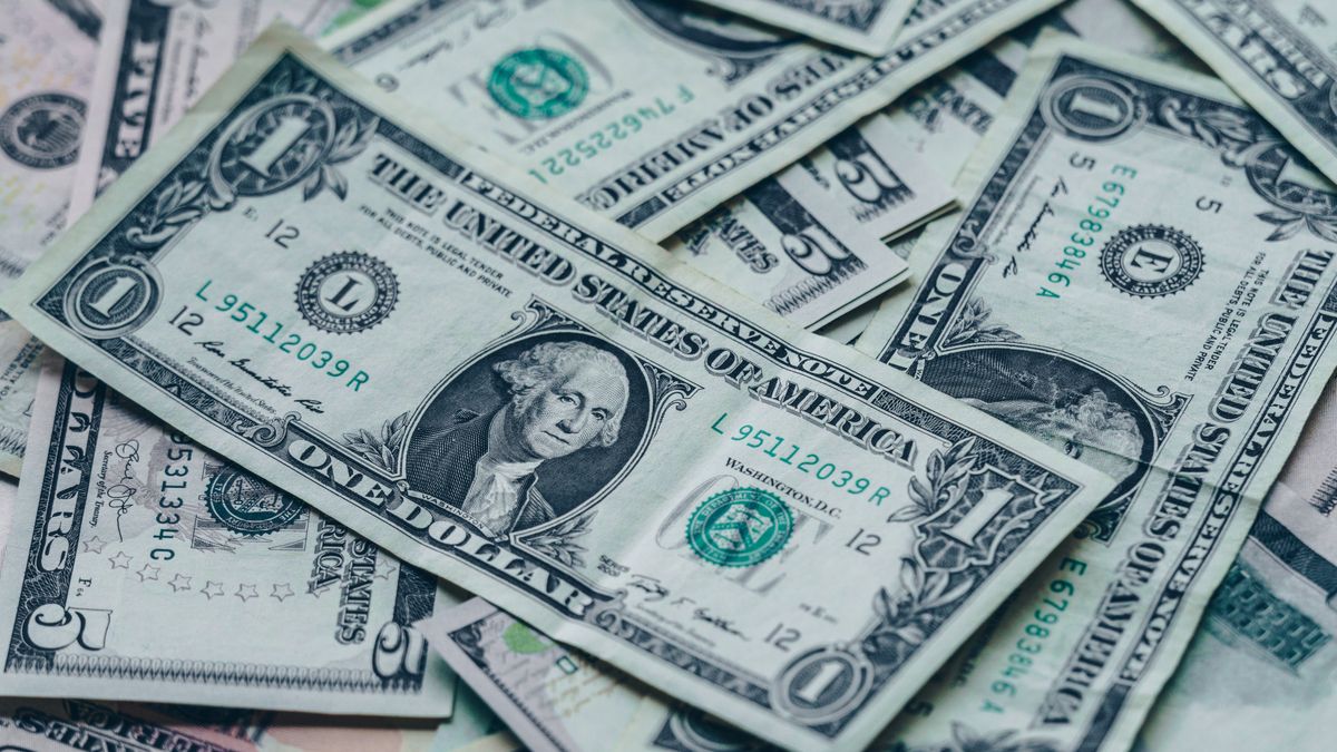 Close-up image of stacked US dollar bills representing wealth and finance.