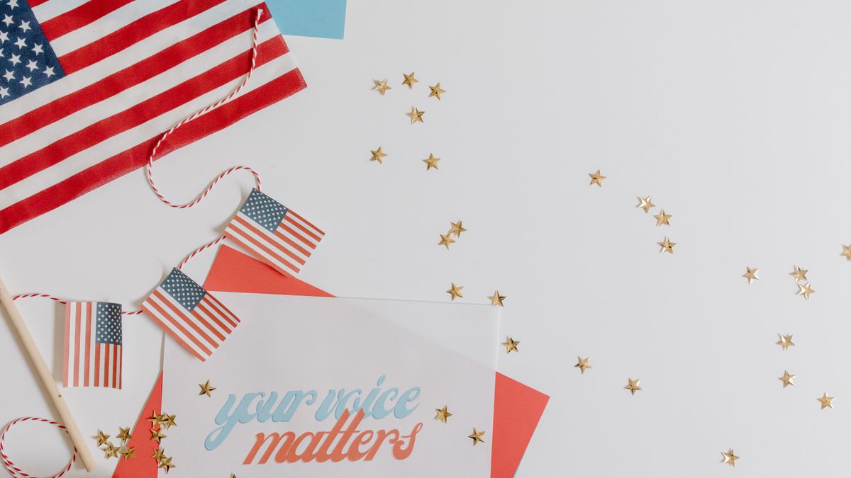 American flag and patriotic decorations on white background promoting democracy.