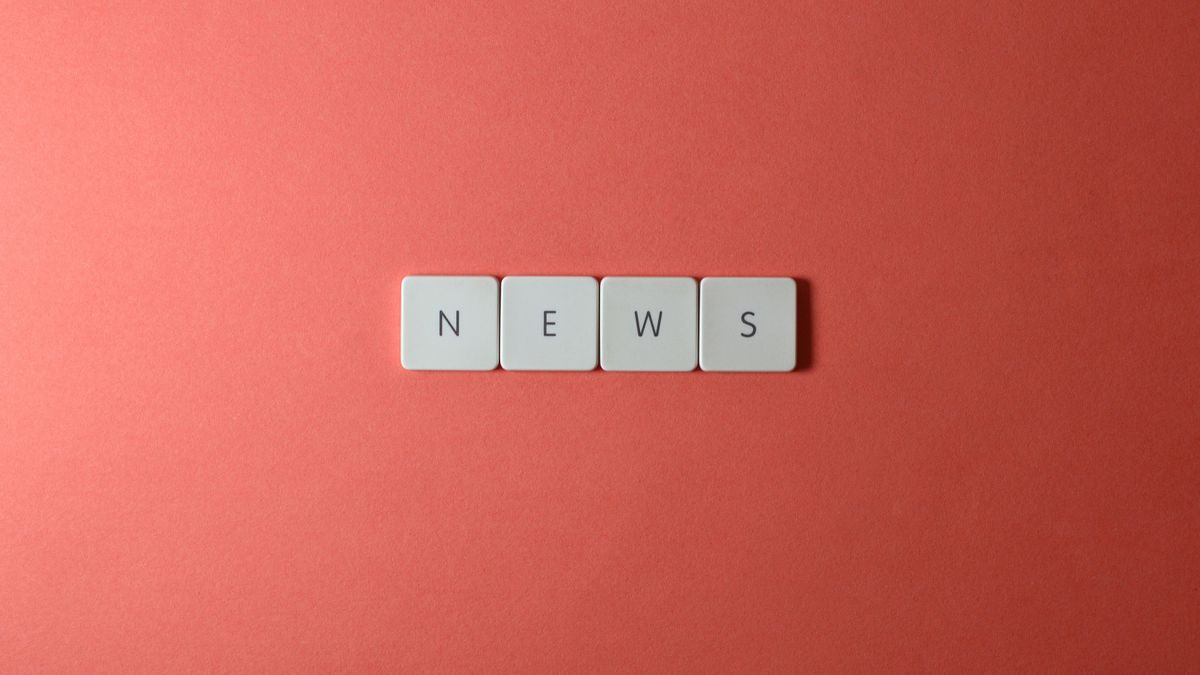 Close-up of keyboard keys spelling 'NEWS' on a red background, minimalist style.