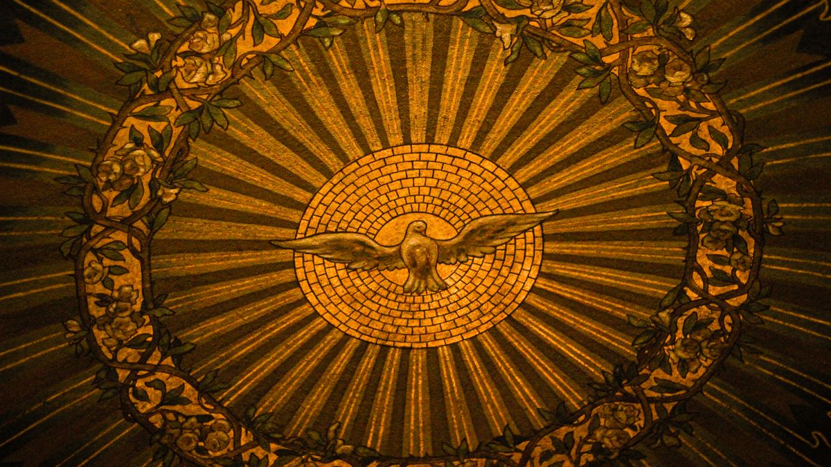 Close-up of intricate stained glass depicting the Holy Spirit in a Buffalo, NY church.