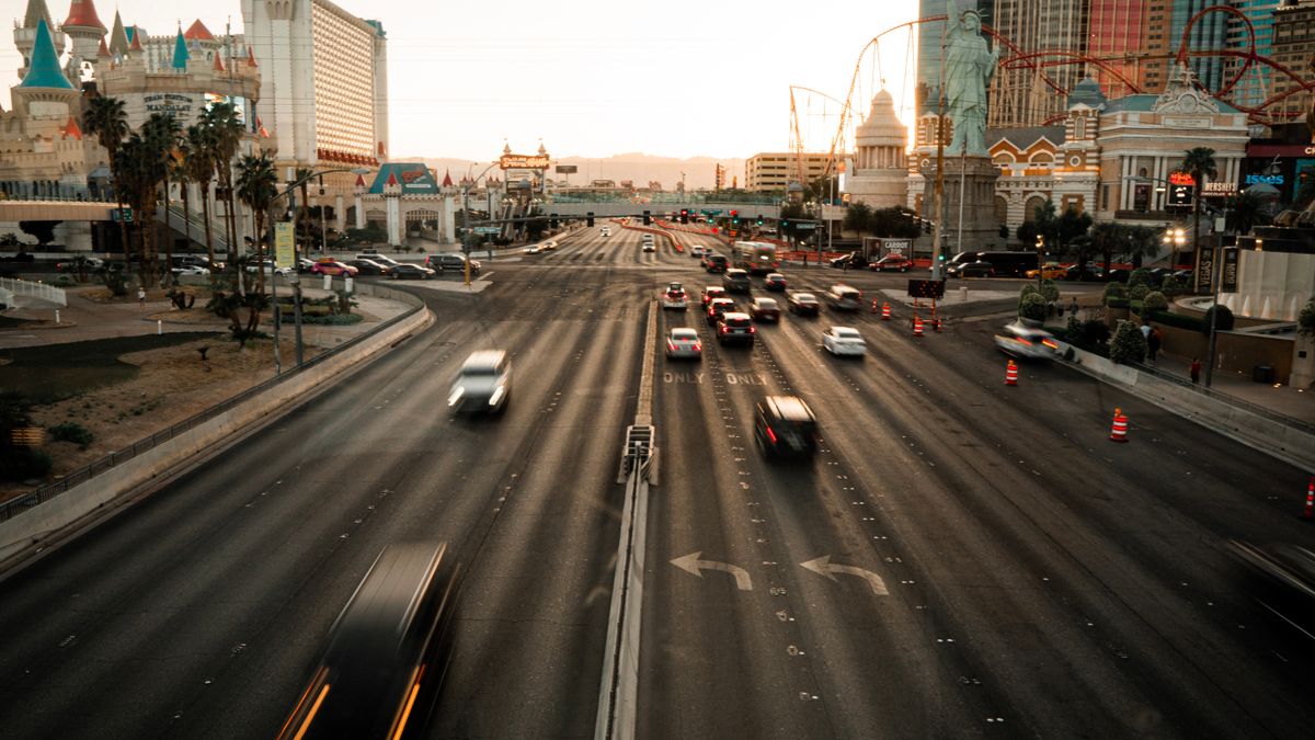 Aerial view of the busy Las Vegas Strip with iconic landmarks during sunset.
