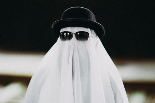 A funny depiction of a ghost wearing a black hat and sunglasses, perfect for Halloween.