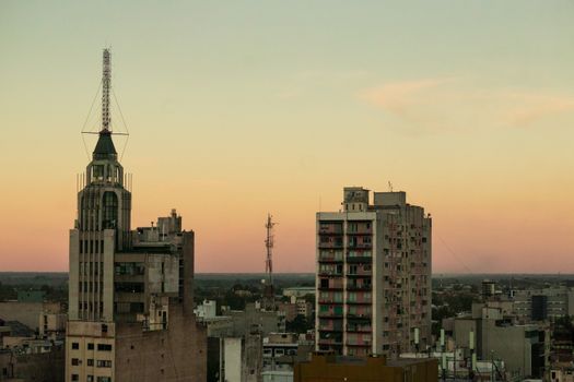 View of Mendoza city skyline at sunset, featuring prominent buildings and towers.
