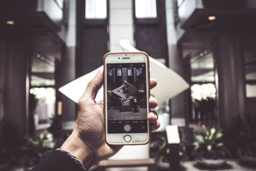 A smartphone capturing an indoor art installation, highlighting modern technology.