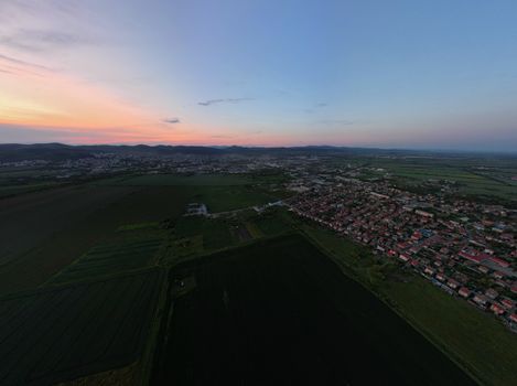 Scenic aerial view of Stara Zagora, Bulgaria during sunset with rural fields and townscape.