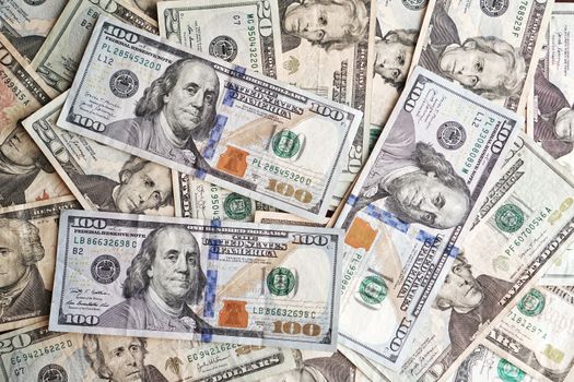 Close-up of various denominations of US dollar banknotes arranged in a pile representing finance and economics.